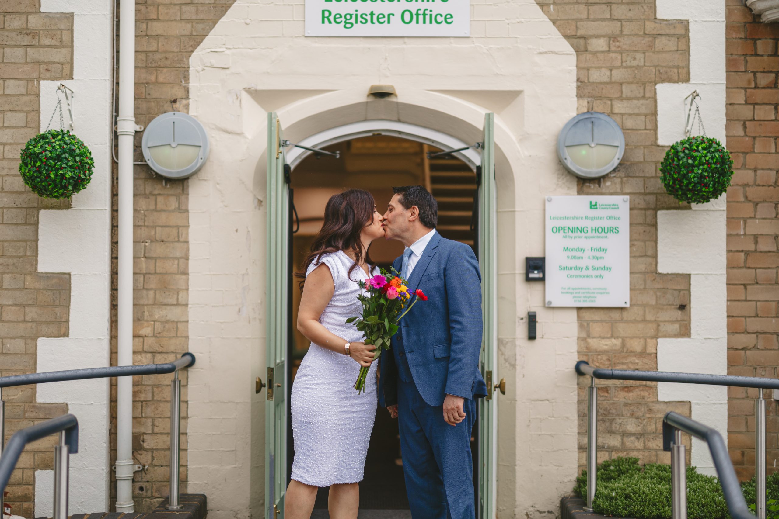 Couple outside Glenfield Registry Office in Leicester after their civil ceremony