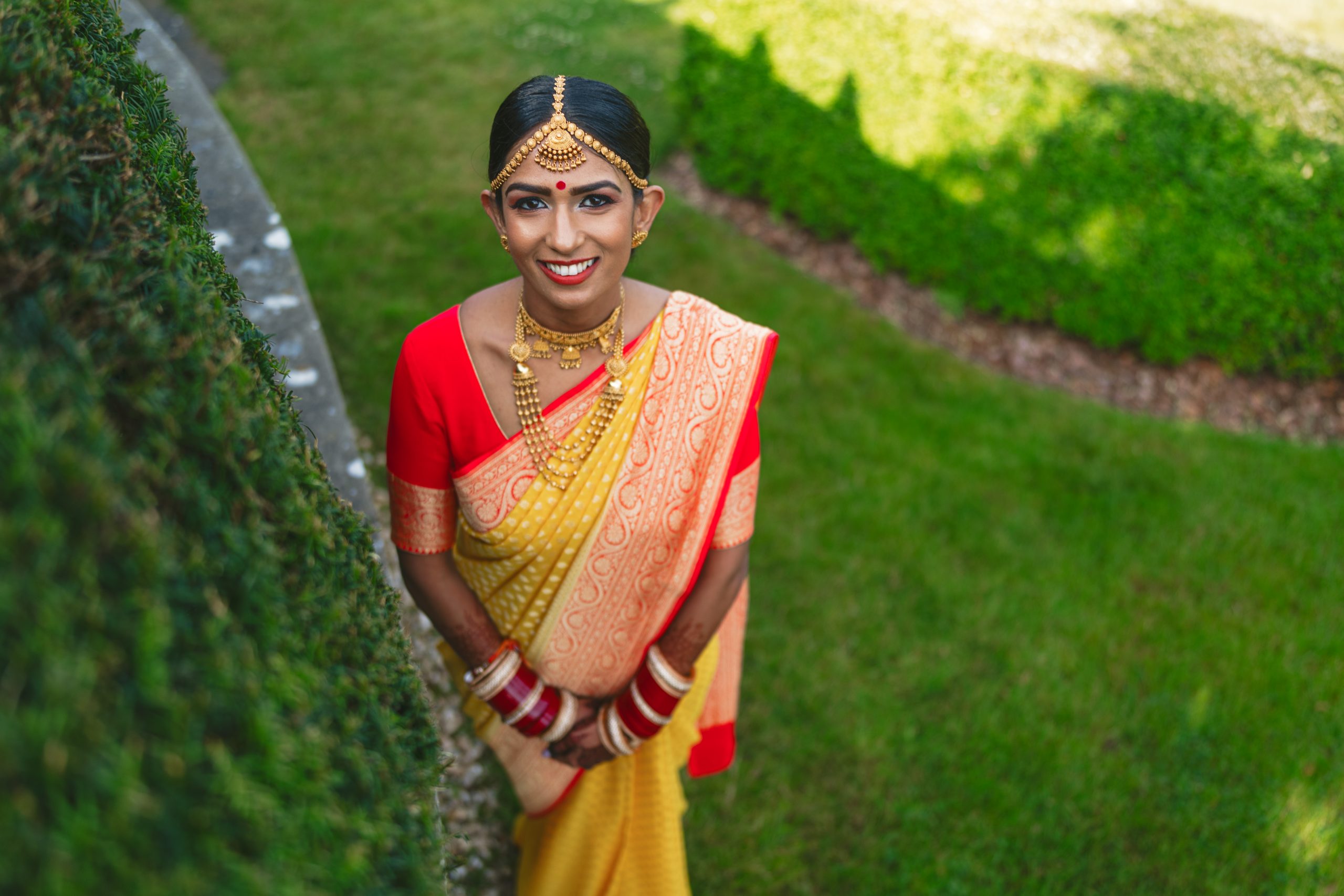 Bride portrait in the gardens during a Hindu wedding at Ladywood Estate