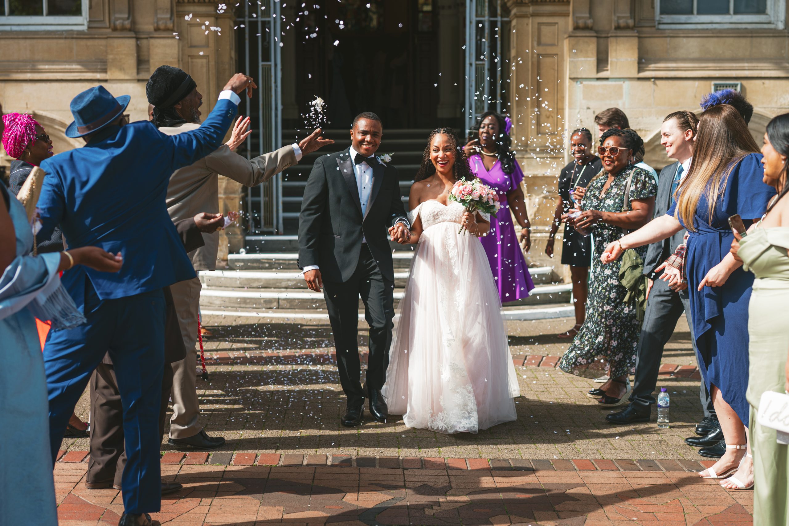Couple walking through confetti after their Town Hall wedding ceremony in Leicester
